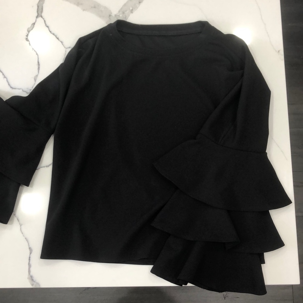Black crewneck blouse with ruffle sleeve accent